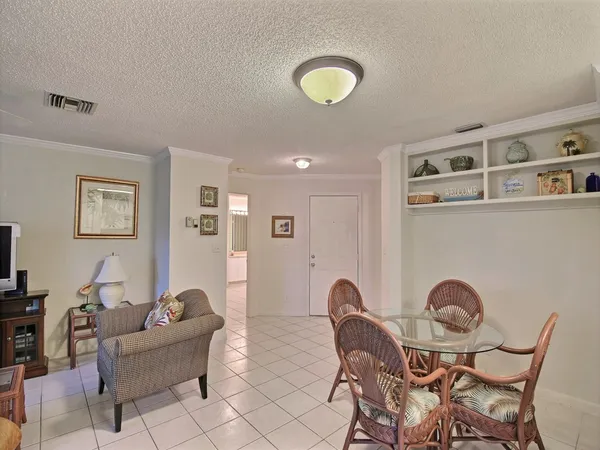 a living room with furniture a couch and potted plant