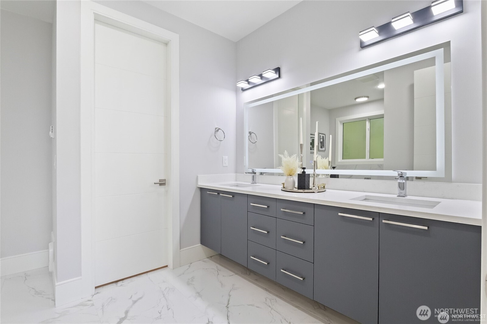 4413 Northeast 26th Court Renton, WA 98059 - Photo 15 of 28 a bathroom with a double vanity sink and a mirror