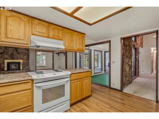 a kitchen view with stainless steel appliances granite countertop a stove and a refrigerator