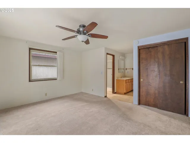 a view of empty room with ceiling fan