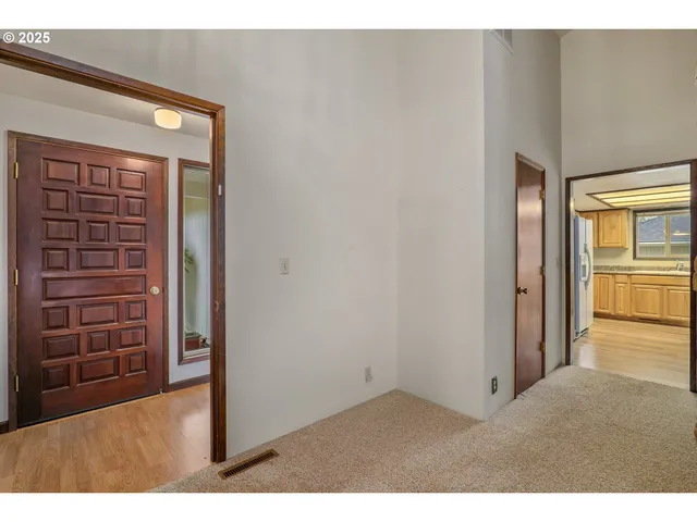 a view of an empty room and fire place