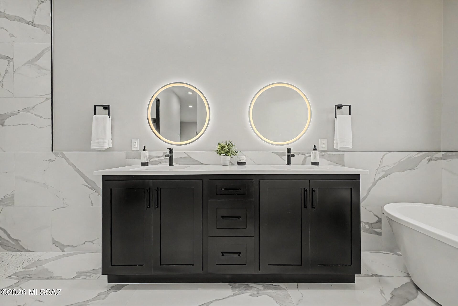 2399 Della Roccia Court Tucson, AZ 85737 - Photo 20 of 34 a bathroom with a double vanity sink and a mirror