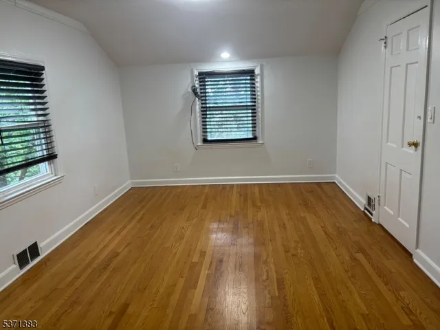 an empty room with wooden floor