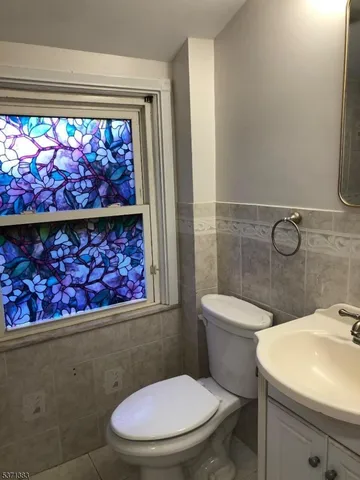 a bathroom with a toilet a sink and a shower curtain