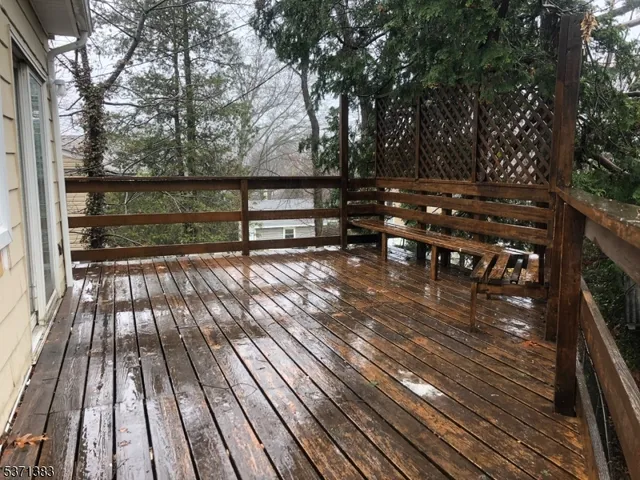 a view of backyard with deck and wooden floor
