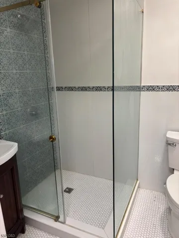 a bathroom with a shower and toilet