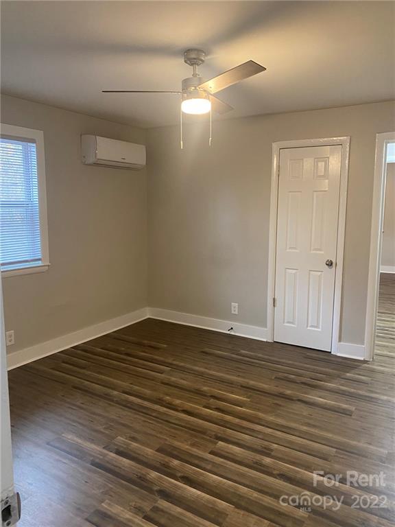 3130 Ridge Avenue Charlotte, NC 28208 - Photo 5 of 12 a view of an empty room with wooden floor and a window