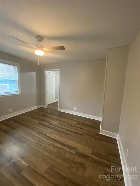 3130 Ridge Avenue Charlotte, NC 28208 - Photo 8 of 12 an empty room with wooden floor and windows