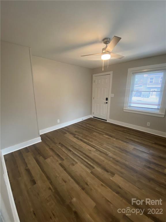 3130 Ridge Avenue Charlotte, NC 28208 - Photo 9 of 12 an empty room with wooden floor fan and windows