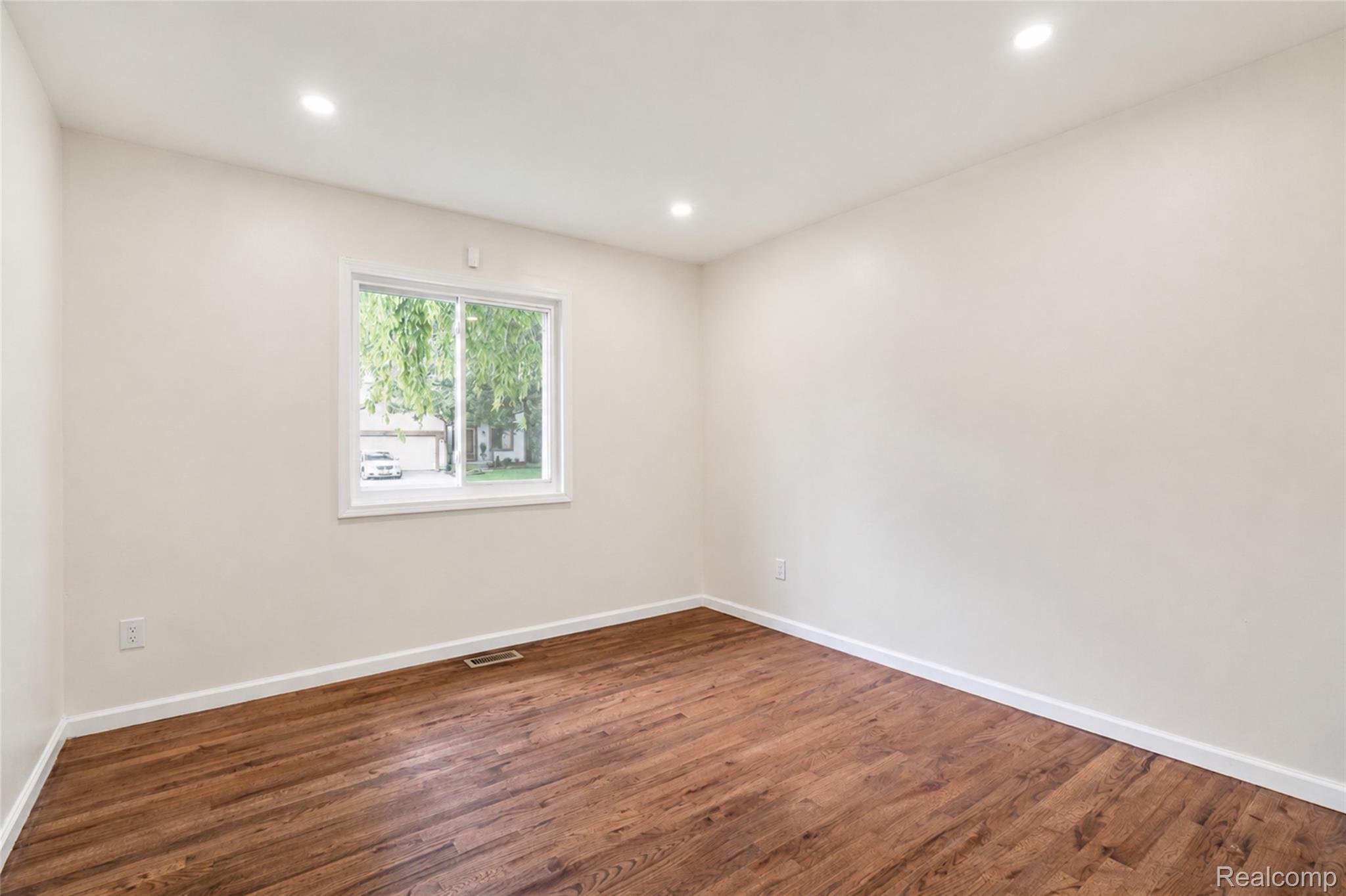 201 Cardwell Street Inkster, MI 48141 - Photo 20 of 41 Room featuring wood-finish flooring, recessed lighting, and a white-framed window