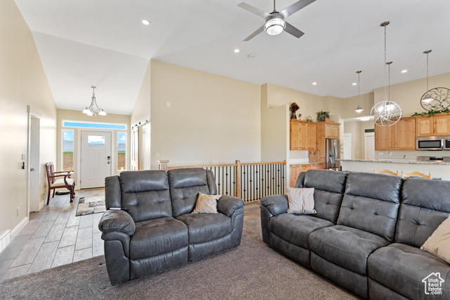 19502 South Olson Road Downey, ID 83234 - Photo 10 of 64 Living area with a chandelier, a ceiling fan, light colored carpet, recessed lighting, and a high ceiling