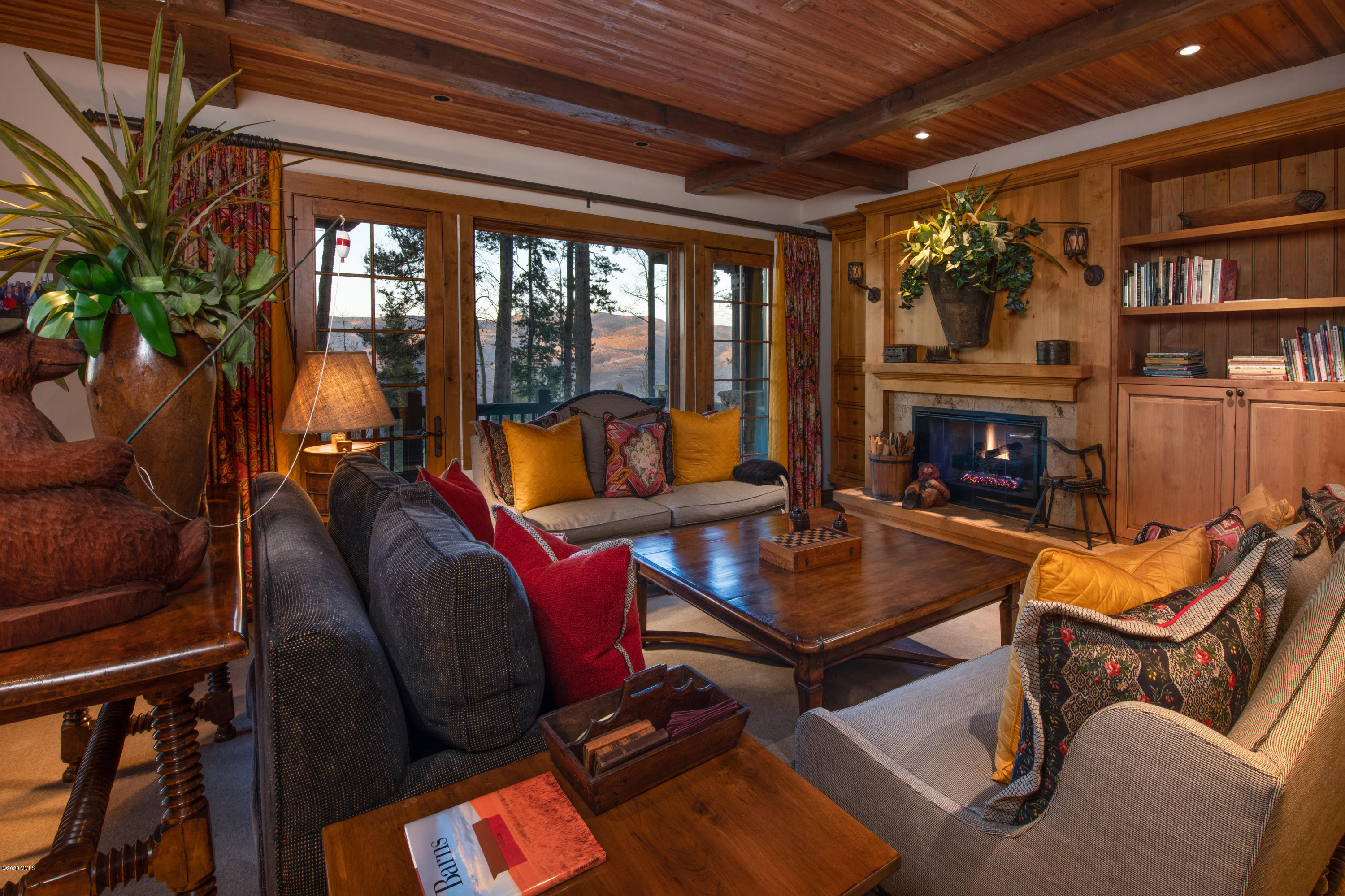 2916 Daybreak Ridge Road Avon, CO 81620 - Photo 13 of 15 a living room with furniture a fireplace and a potted plant