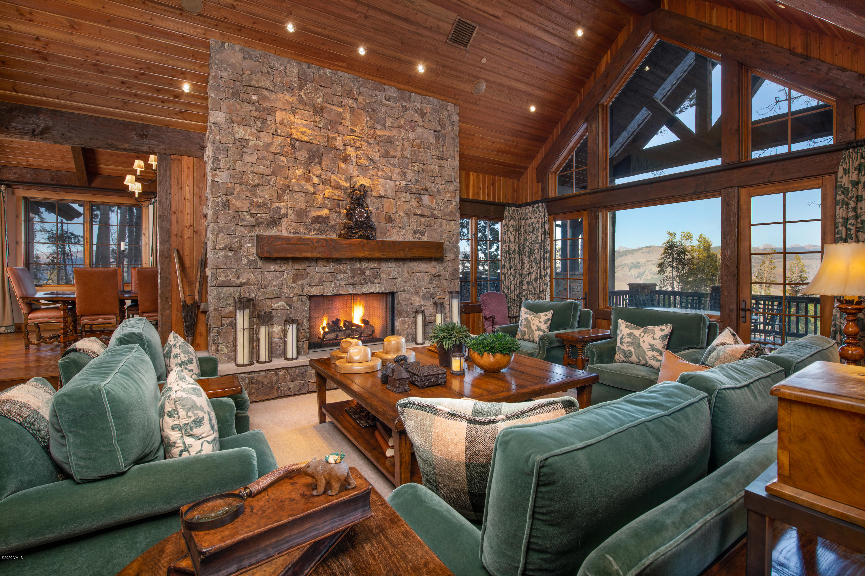 2916 Daybreak Ridge Road Avon, CO 81620 - Photo 2 of 15 a living room with furniture a fireplace and a large window