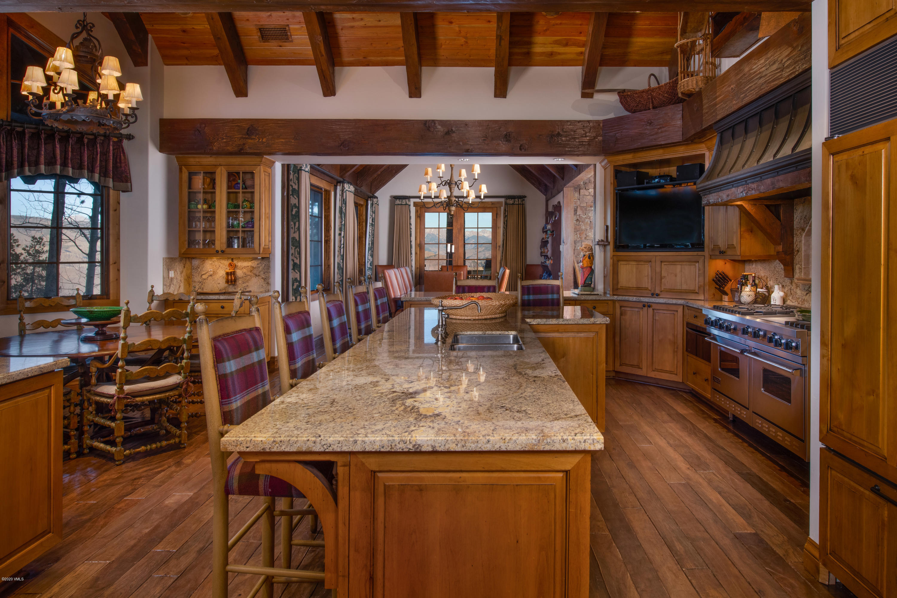 2916 Daybreak Ridge Road Avon, CO 81620 - Photo 7 of 15 a view of a kitchen and dining area with wooden floor