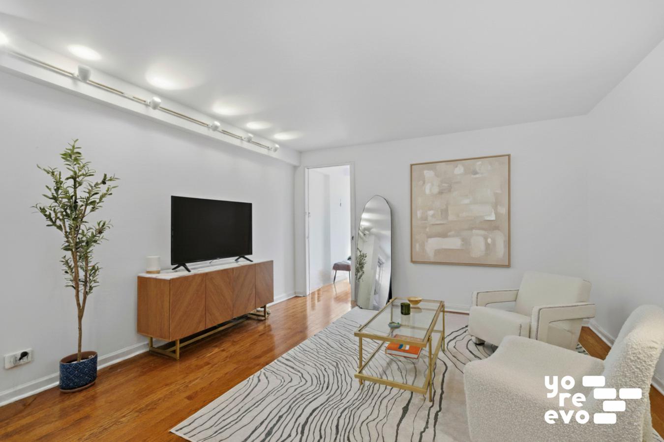 142 East 16th Street, Unit 8C Manhattan, NY 10003 - Photo 2 of 8 a living room with furniture and a flat screen tv
