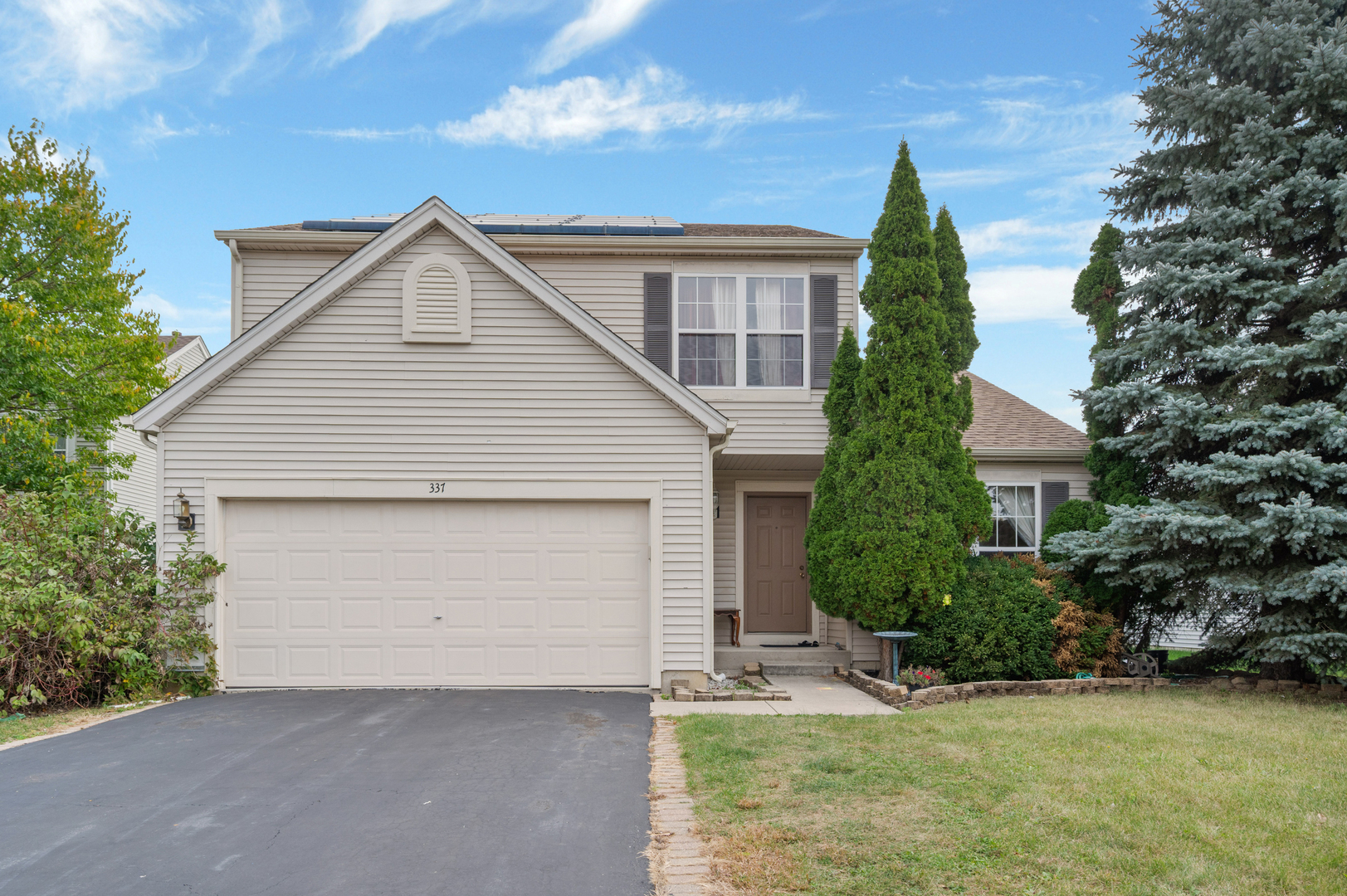 337 Daffodil Drive Romeoville, IL 60446 - Photo 1 of 1 front view of house with a yard and trees all around