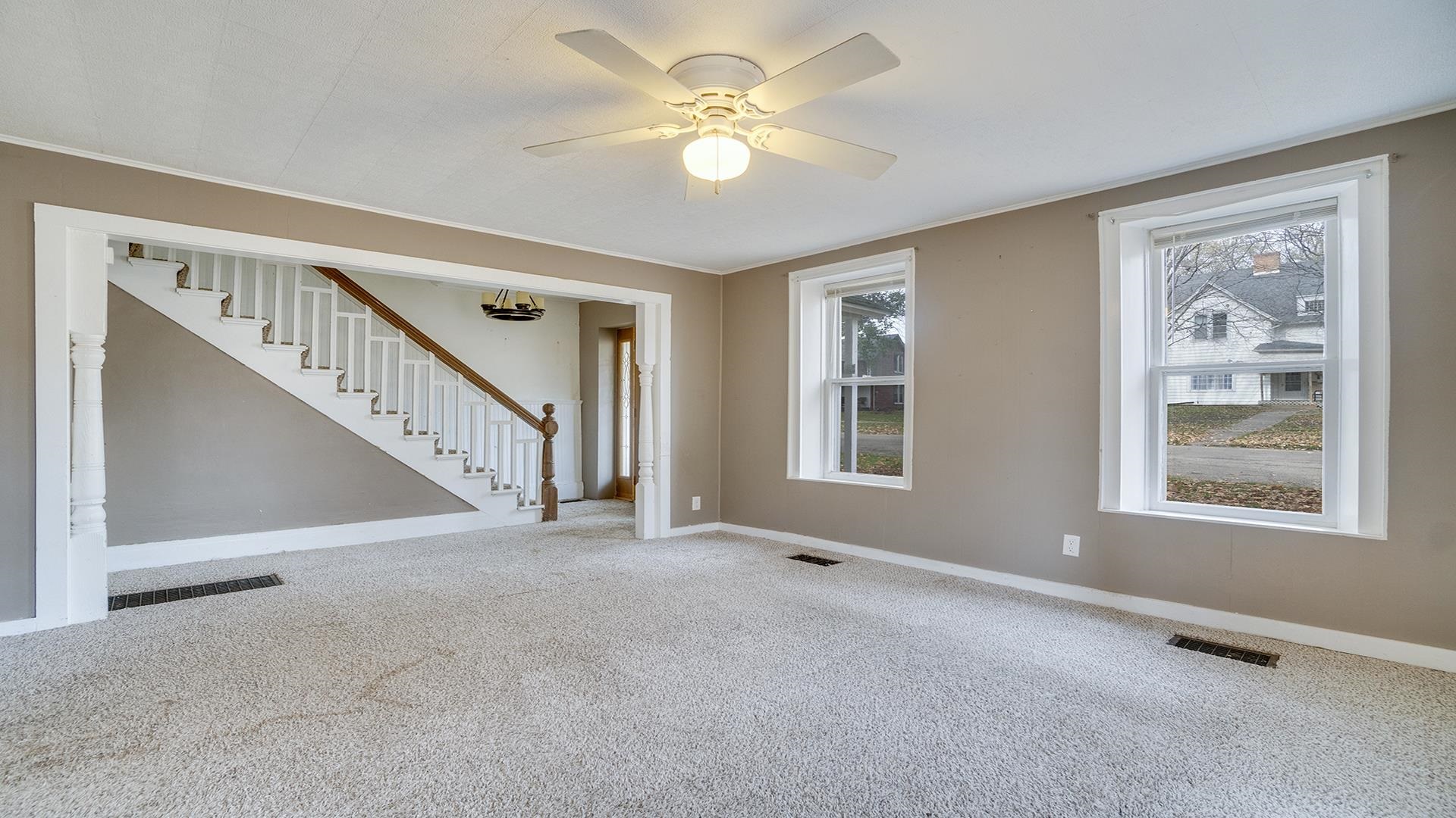201 West Center Street Mount Morris, IL 61054 - Photo 5 of 33 a view of an empty room with chandelier fan and window