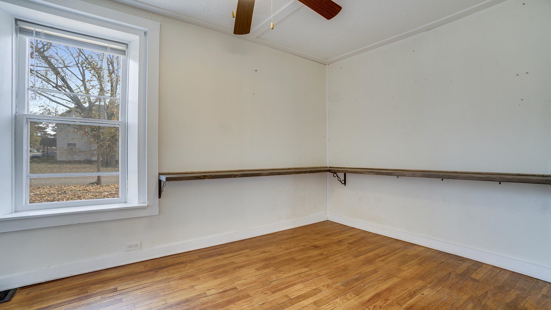201 West Center Street Mount Morris, IL 61054 - Photo 9 of 33 a view of a room with a wooden floor and a window