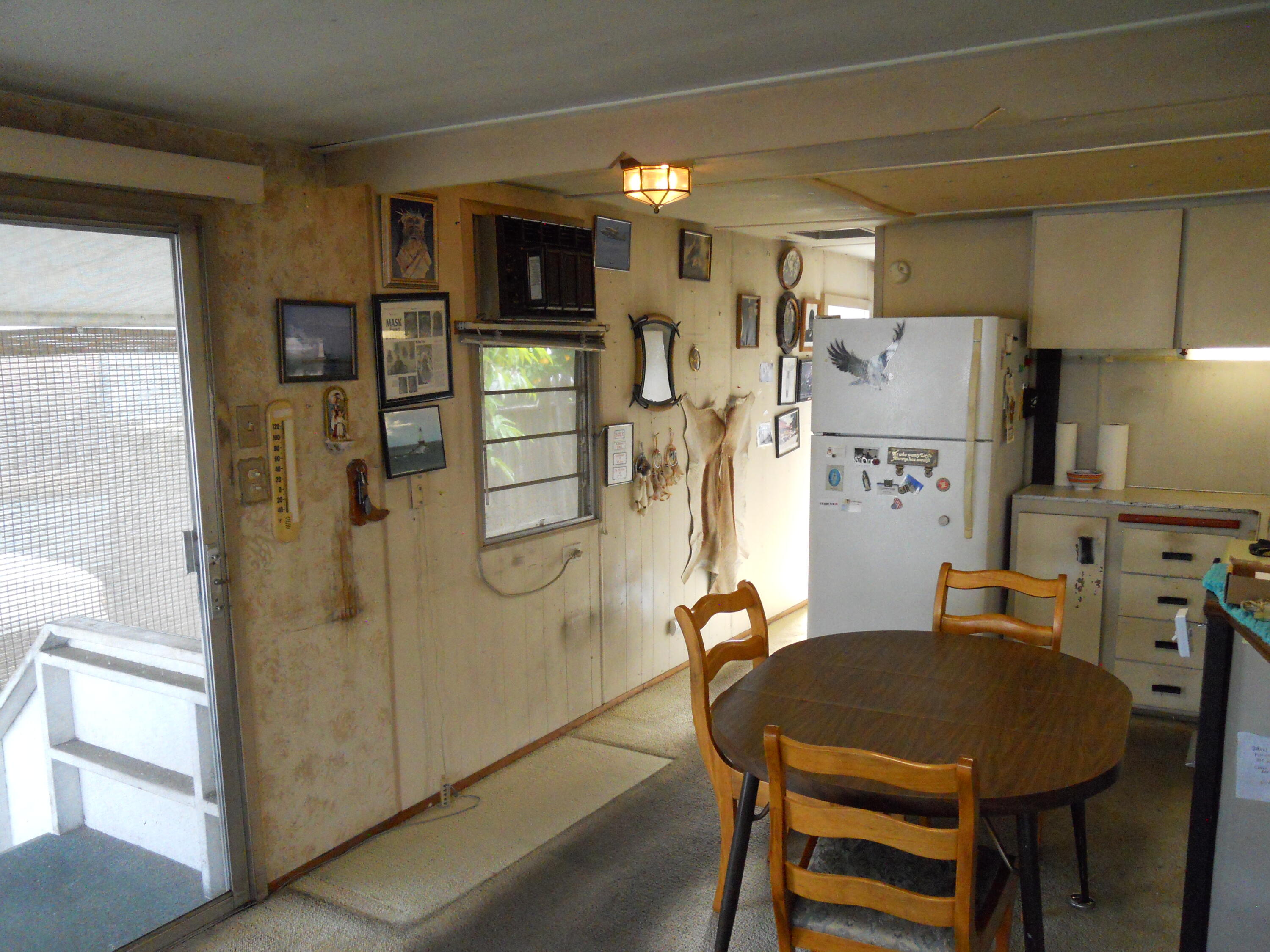 520 Pine Avenue, Unit 25 Goleta, CA 93117 - Photo 7 of 9 a dining room with stainless steel appliances a refrigerator and a dining table with wooden floor