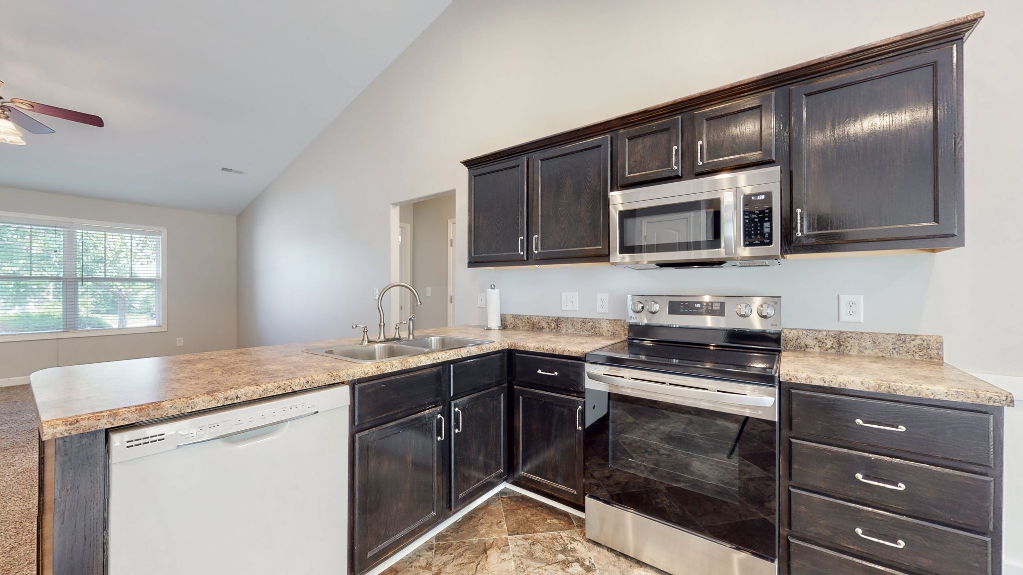 6025 Chickadee Circle Spring Hill, TN 37174 - Photo 11 of 44 a kitchen with a sink stove and microwave