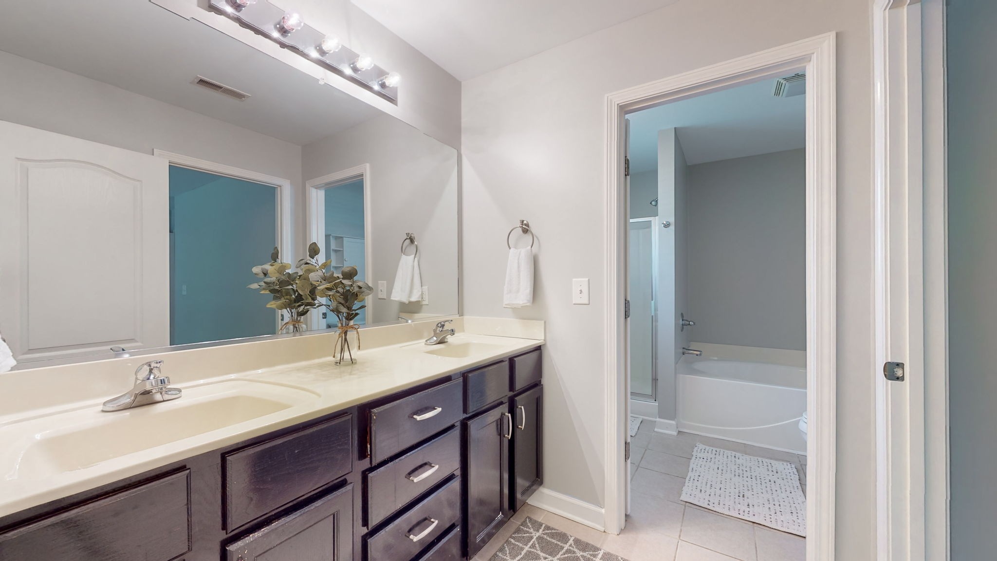 6025 Chickadee Circle Spring Hill, TN 37174 - Photo 16 of 44 a bathroom with a double vanity sink and a mirror
