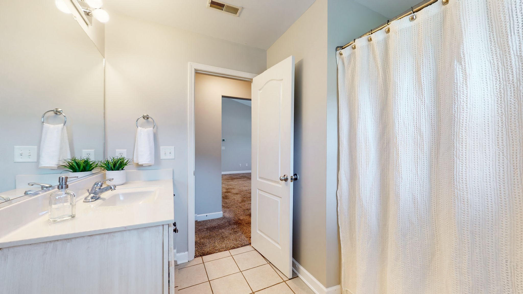 6025 Chickadee Circle Spring Hill, TN 37174 - Photo 25 of 44 a bathroom with a sink a mirror and a shower