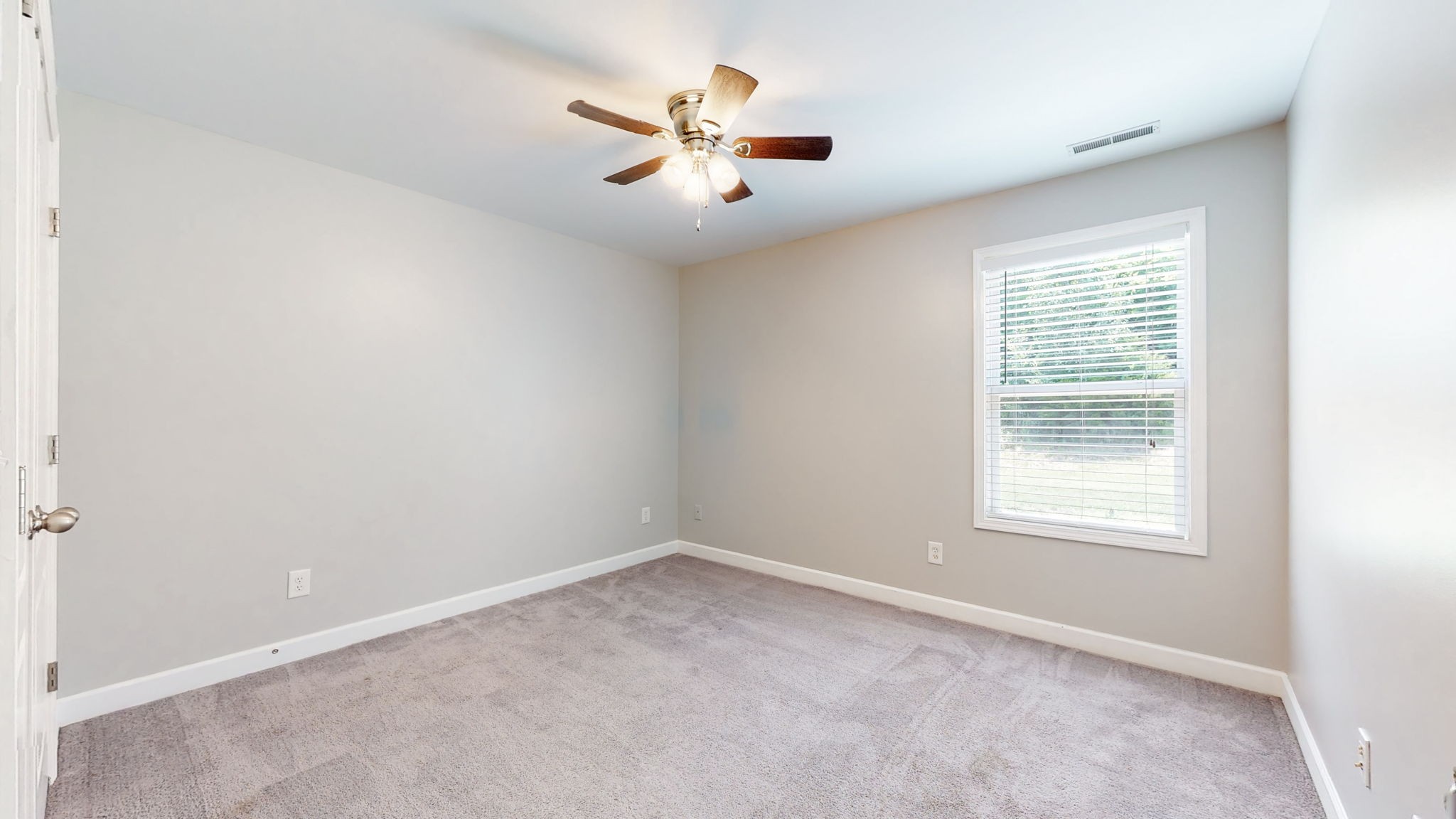 6025 Chickadee Circle Spring Hill, TN 37174 - Photo 26 of 44 an empty room with chandelier fan and windows