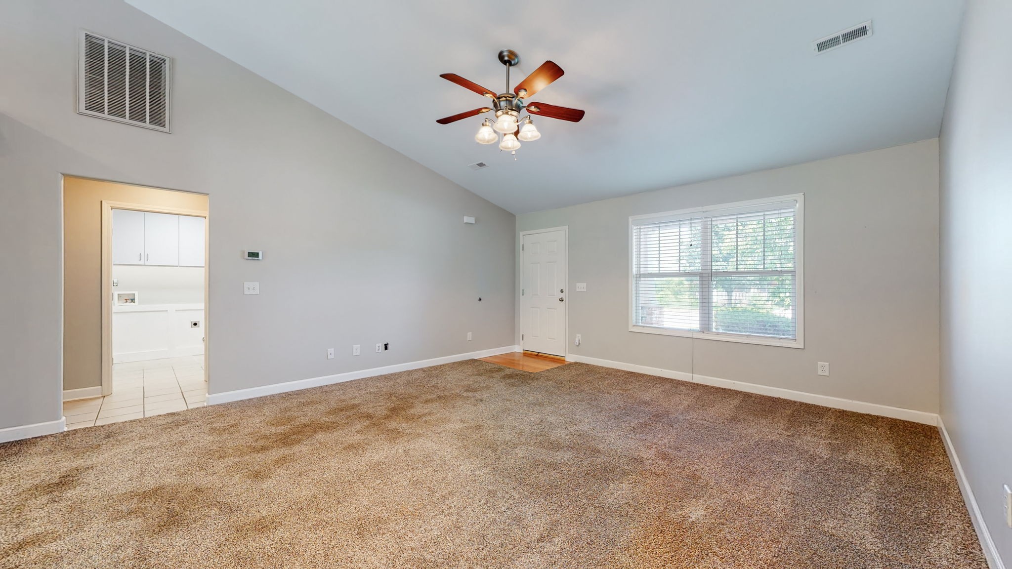 6025 Chickadee Circle Spring Hill, TN 37174 - Photo 7 of 44 a view of an empty room with a ceiling fan and a window