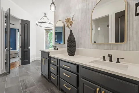 a bathroom with a sink a vanity and a mirror