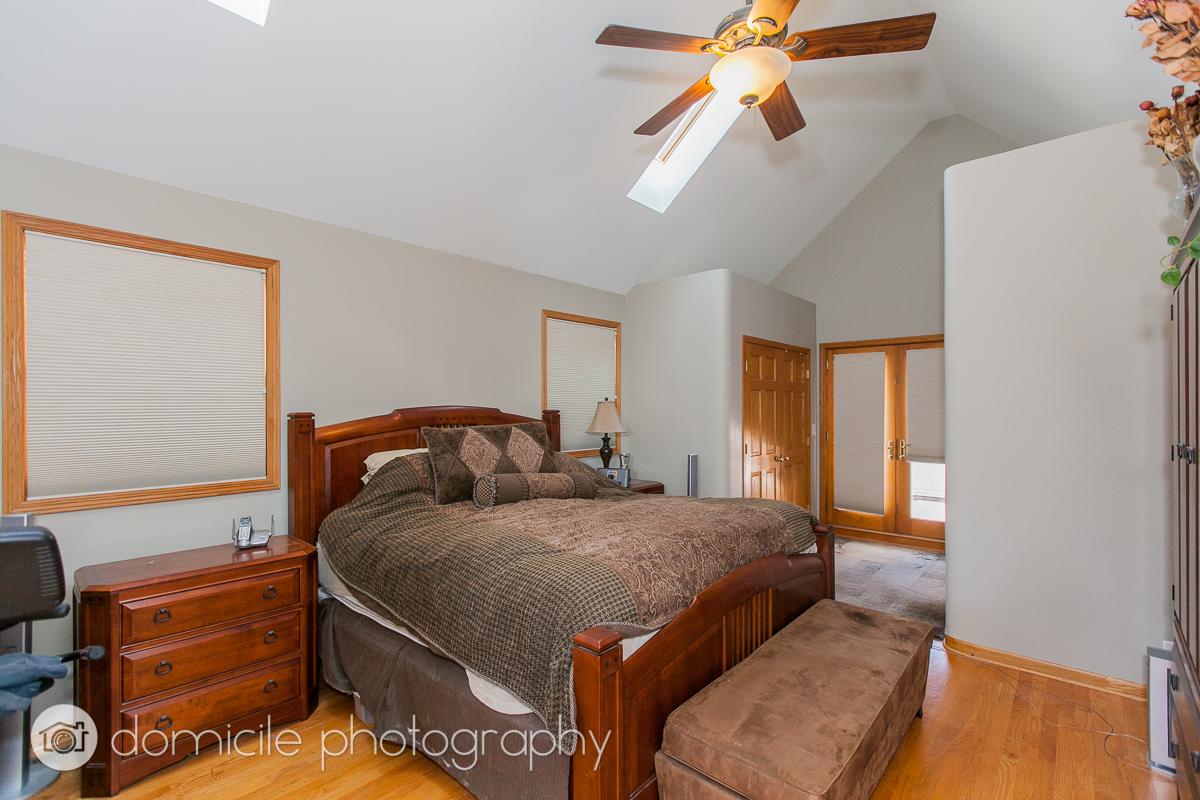 Undisclosed Address Chicago, IL 60618 - Photo 13 of 20 a bedroom with a bed and a chandelier