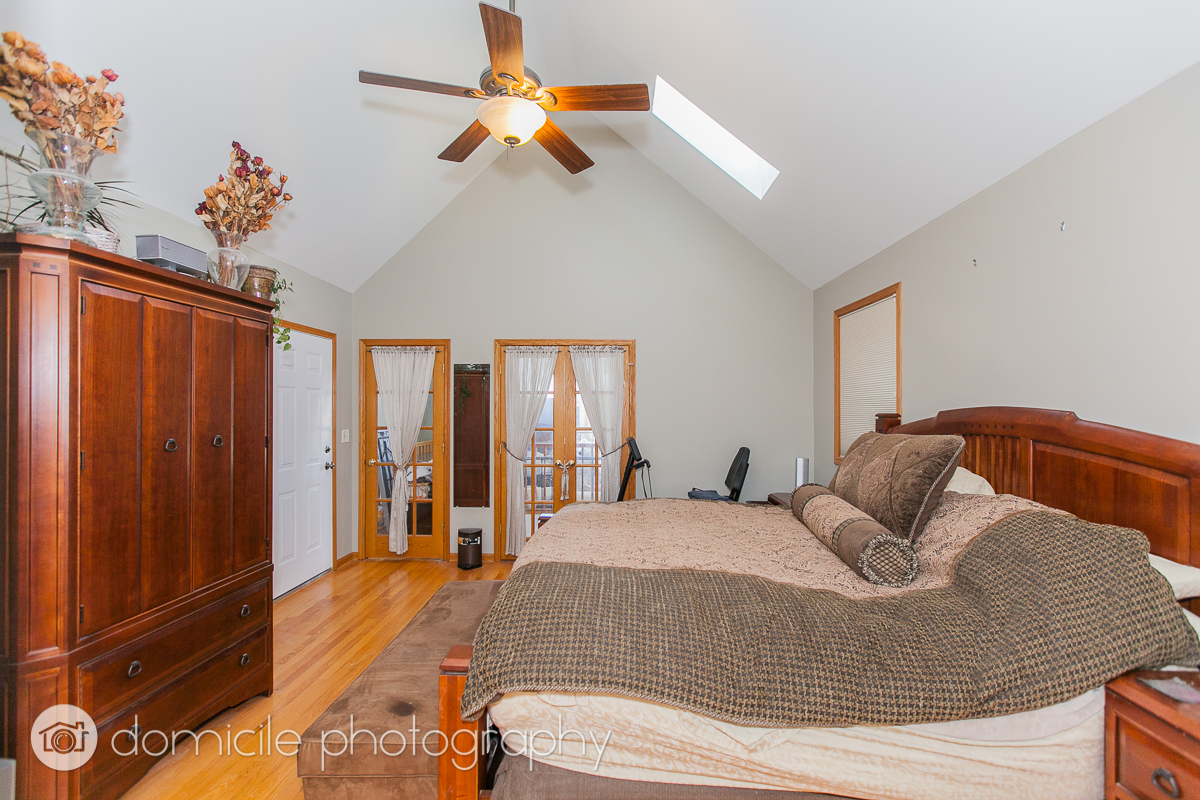 Undisclosed Address Chicago, IL 60618 - Photo 14 of 20 a bedroom with a bed and a chandelier