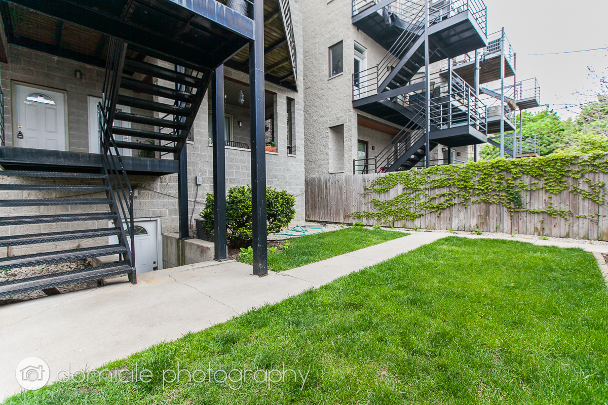Undisclosed Address Chicago, IL 60618 - Photo 18 of 20 a view of a house with a small yard and plants
