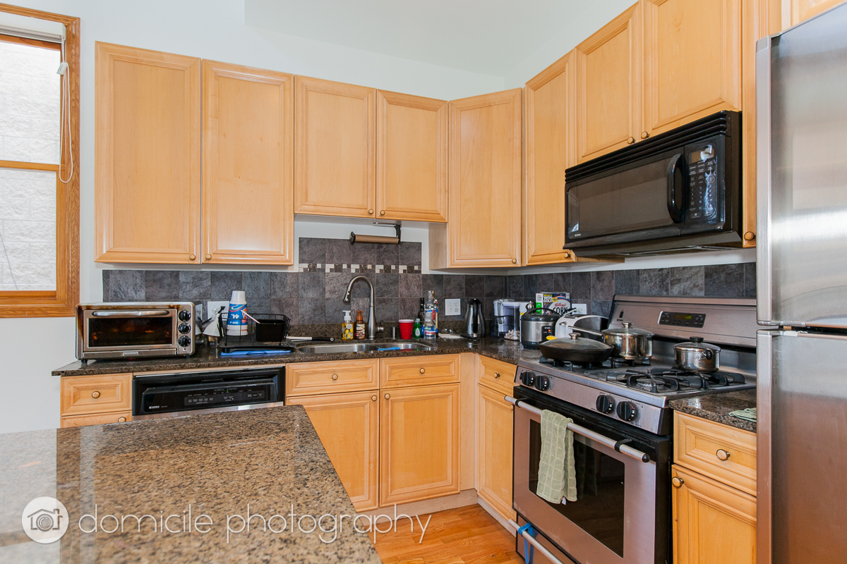 Undisclosed Address Chicago, IL 60618 - Photo 3 of 20 a kitchen with stainless steel appliances a stove a sink a microwave and cabinets