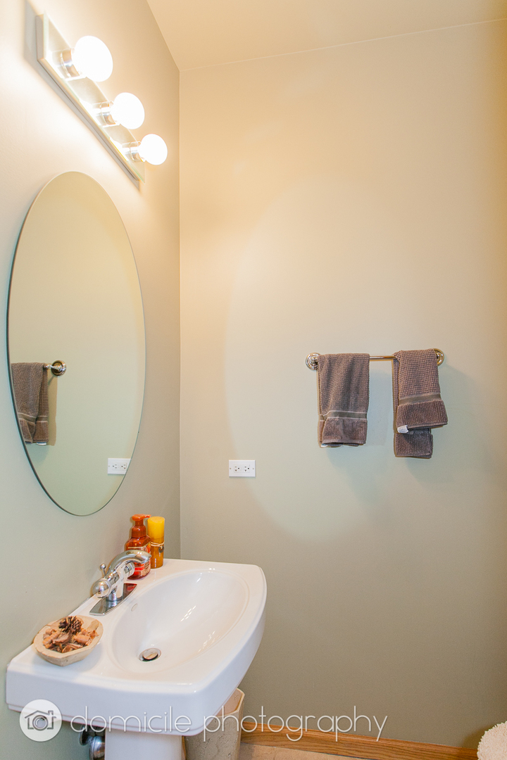 Undisclosed Address Chicago, IL 60618 - Photo 8 of 20 a bathroom with a sink and a mirror