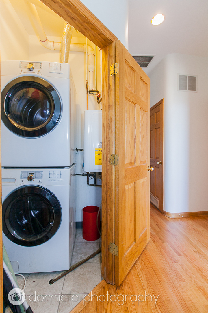 Undisclosed Address Chicago, IL 60618 - Photo 9 of 20 a view of a hallway with washer and dryer