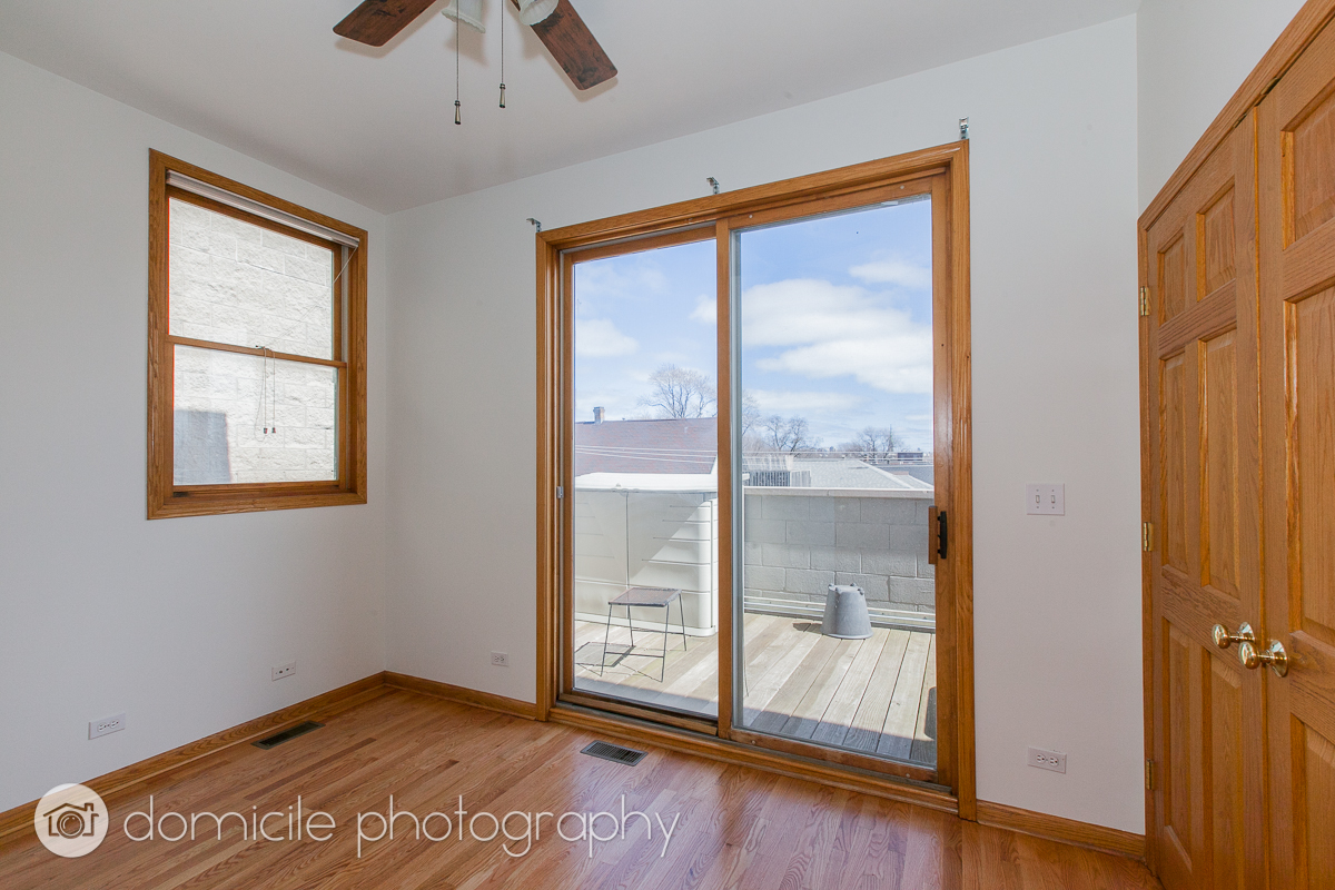 Undisclosed Address Chicago, IL 60618 - Photo 10 of 20 a view of an empty room with a window and wooden floor