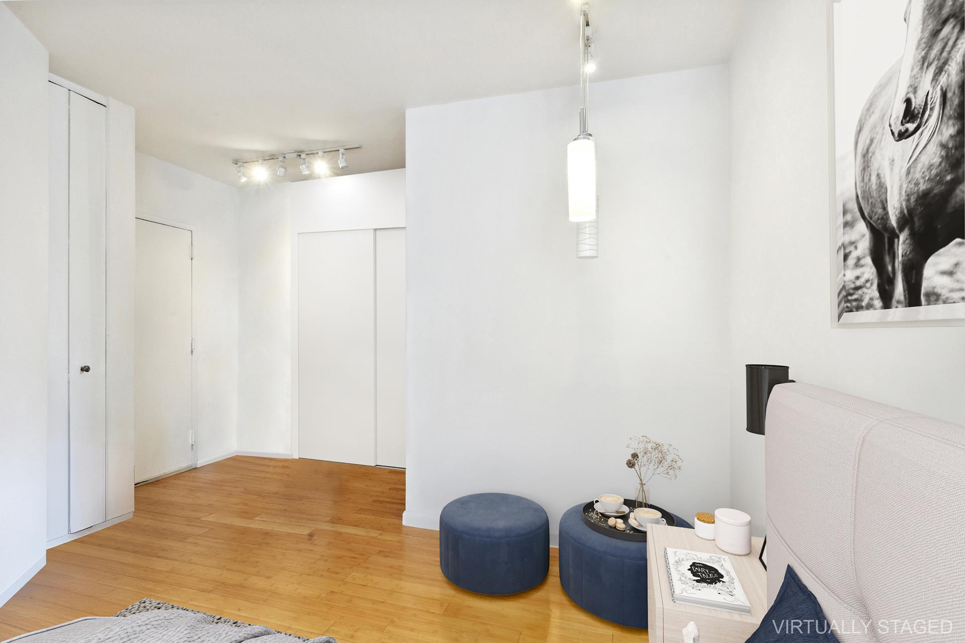 380 Rector Place, Unit 9J Manhattan, NY 10280 - Photo 2 of 7 a bedroom with a bed and a couch