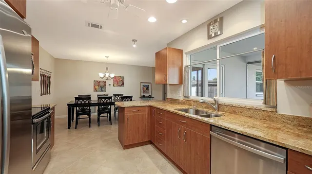 a large kitchen with cabinets table and chairs