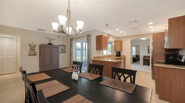 a large kitchen with a table and chairs
