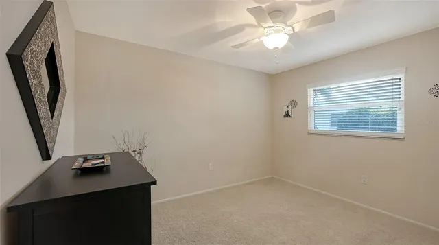 a view of a workspace with furniture and a window