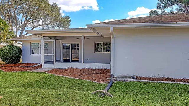 a view of a backyard with a barbeque grill and plants
