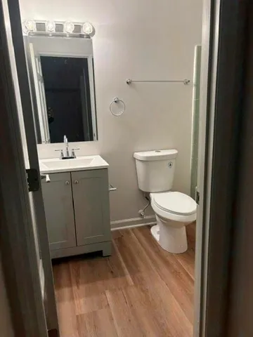a bathroom with a toilet sink and mirror