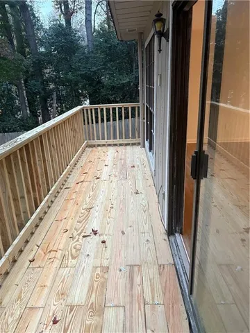 a view of balcony with wooden floor and fence