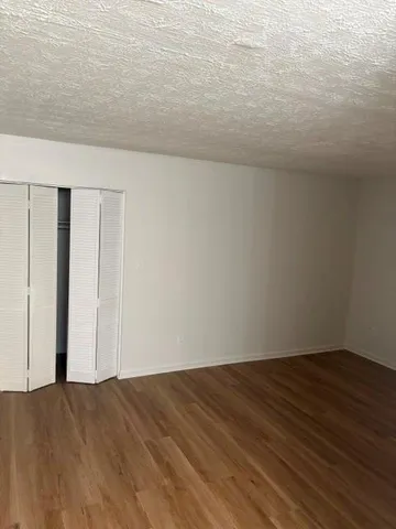 an empty room with wooden floor