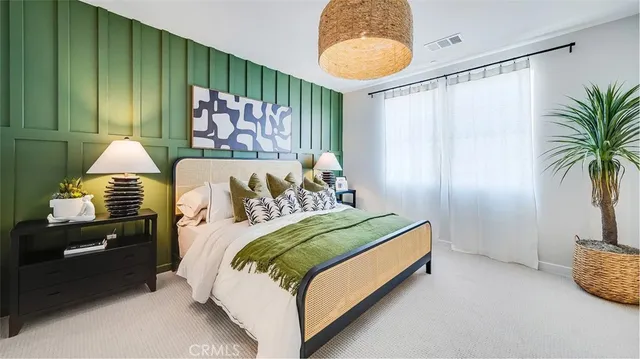 a bedroom with a bed and painting on the wall