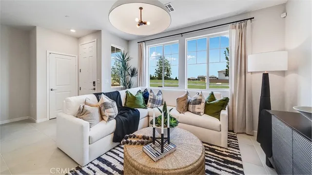 a living room with furniture and a large window