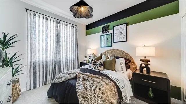 a bedroom with a bed and a large mirror