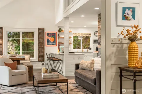 a bedroom with furniture and a large window