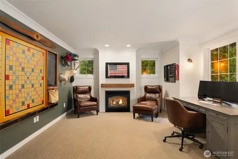 a livingroom with workspace fireplace and a couch