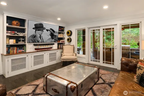 a living room with furniture a window and gym equipment